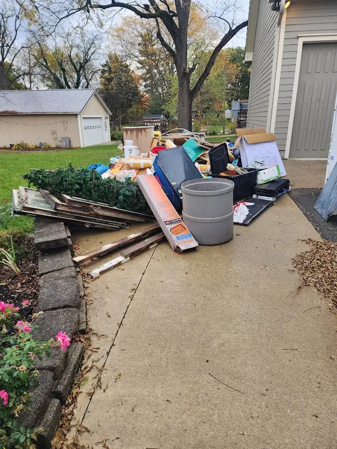 Dumpster being loaded with debris for 12 Yard Dumpster Rental in Hardin